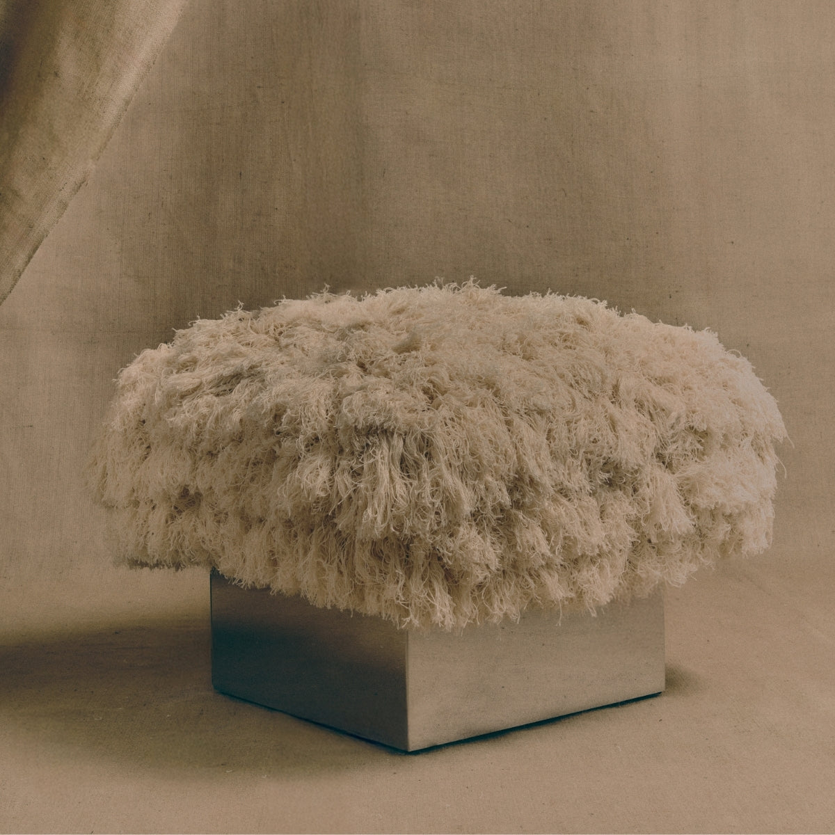 The CLIFTON IN COUTURE fray ottoman